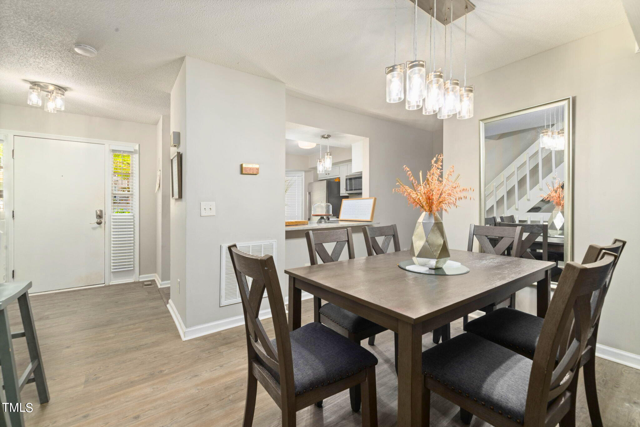5955 Dixon Drive Raleigh, NC 27609 - Photo 8 of 26 a view of a dining room with furniture and chandelier