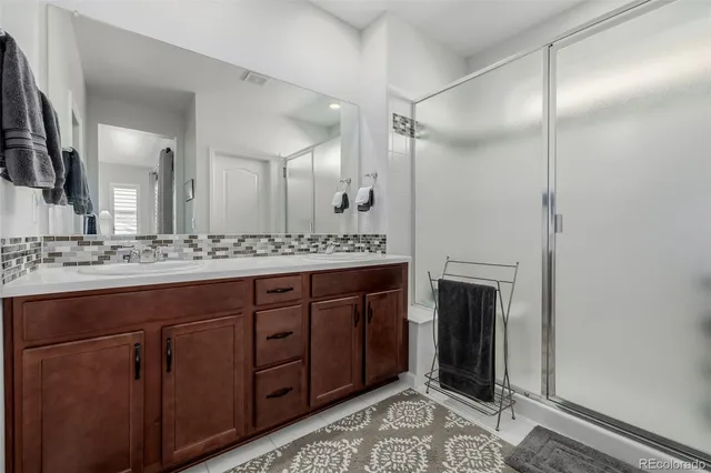 a spacious bathroom with a granite countertop sink and a mirror