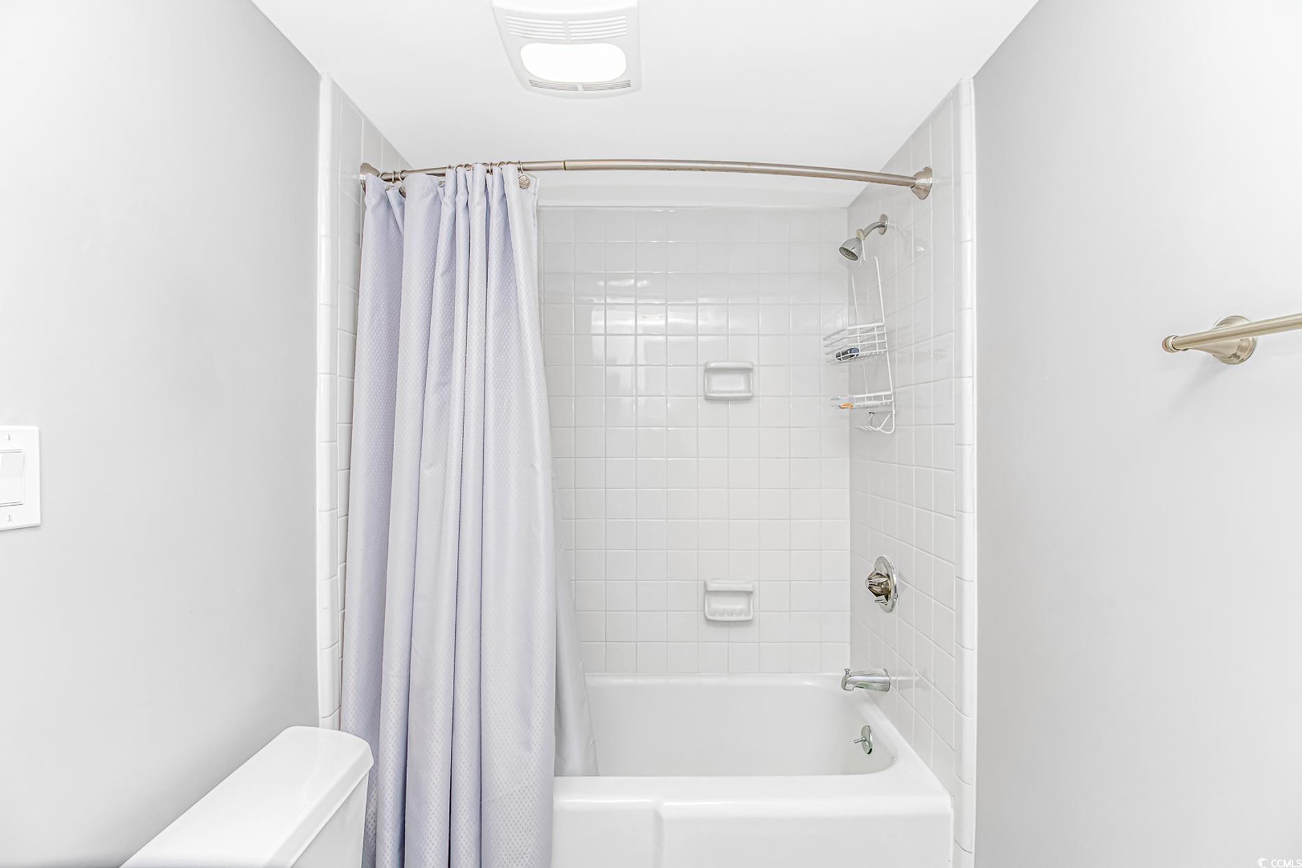 10100 Beach Club Drive, Unit 2B Myrtle Beach, SC 29572 - Photo 14 of 30 Full bath with shower / bathtub combination with curtain and toilet