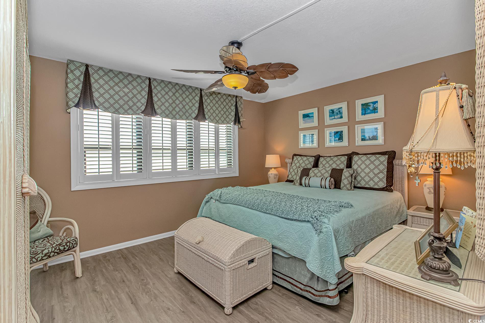 10100 Beach Club Drive, Unit 2B Myrtle Beach, SC 29572 - Photo 15 of 30 Bedroom featuring wood finished floors and ceiling fan