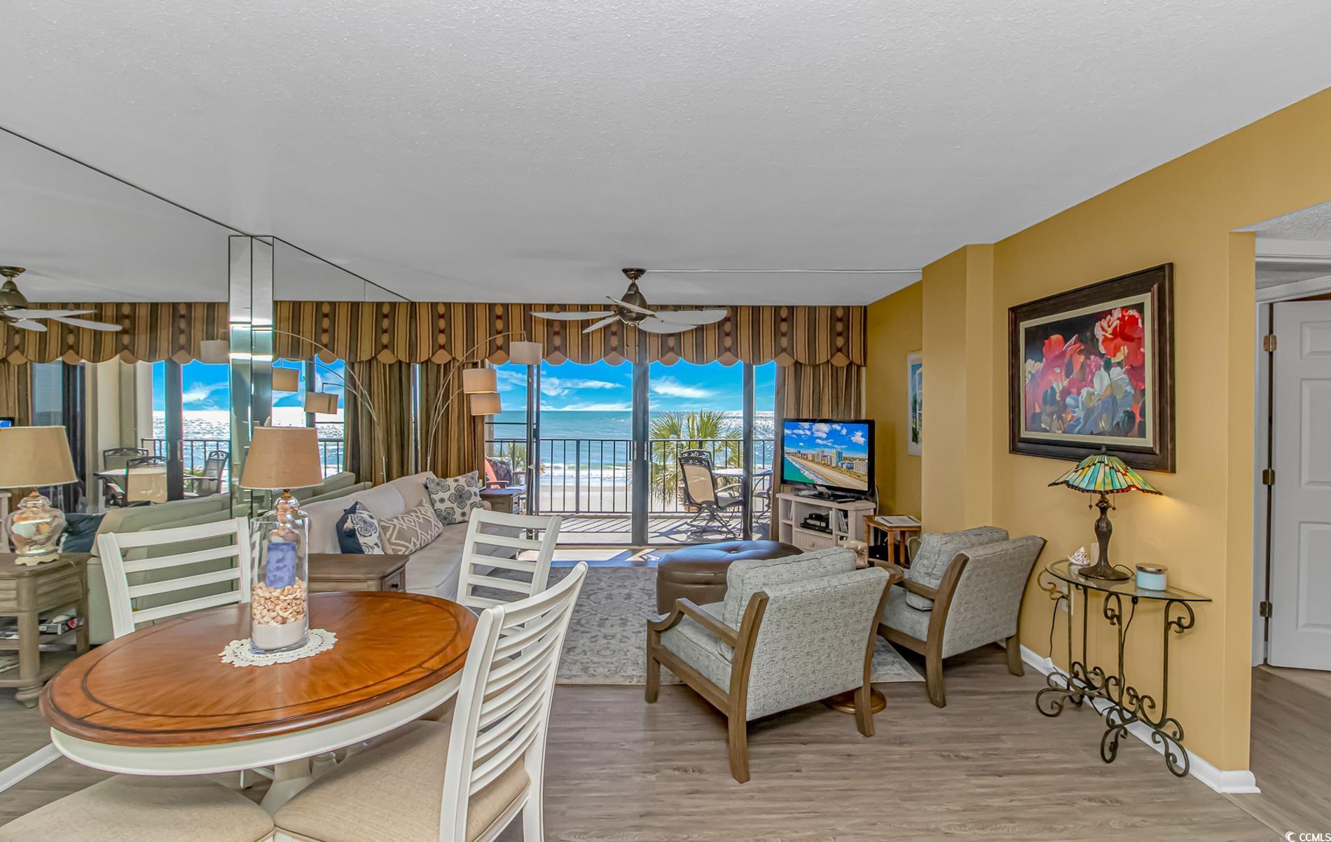 10100 Beach Club Drive, Unit 2B Myrtle Beach, SC 29572 - Photo 6 of 30 Living room featuring ceiling fan, light wood finished floors, and a textured ceiling