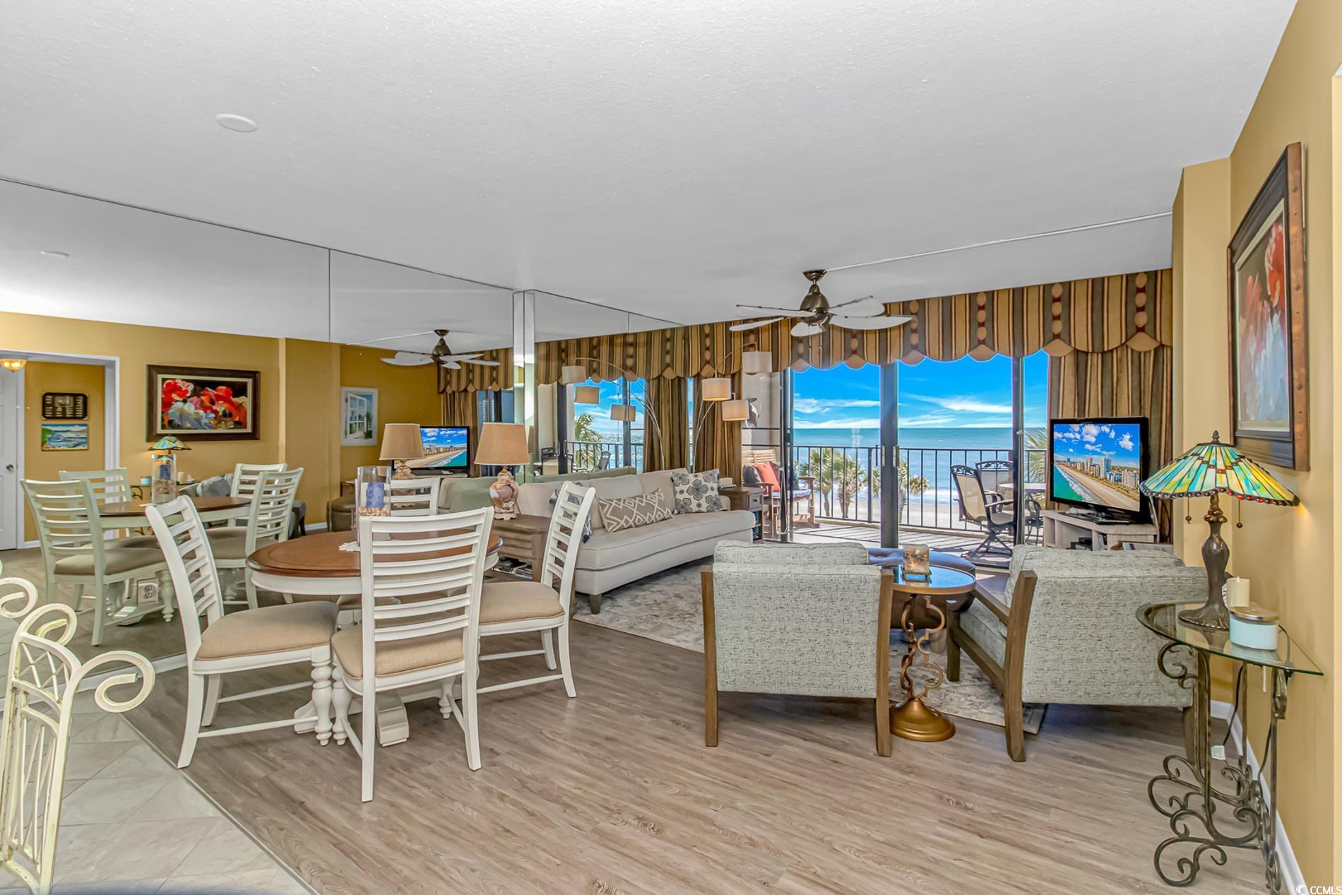10100 Beach Club Drive, Unit 2B Myrtle Beach, SC 29572 - Photo 7 of 30 Living area with light wood-style floors and ceiling fan