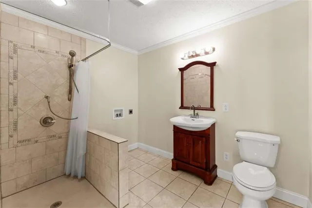 a bathroom with a toilet a sink and shower