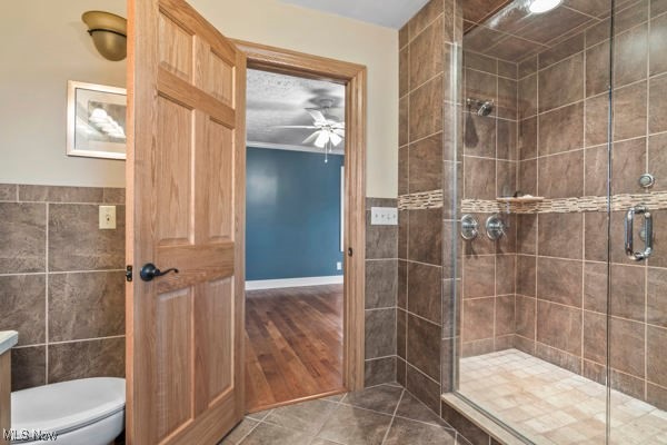 14413 Macklin Road New Springfield, OH 44443 - Photo 25 of 49 Full bathroom with dark tile patterned flooring, a shower stall, vanity, tile walls, and ceiling fan