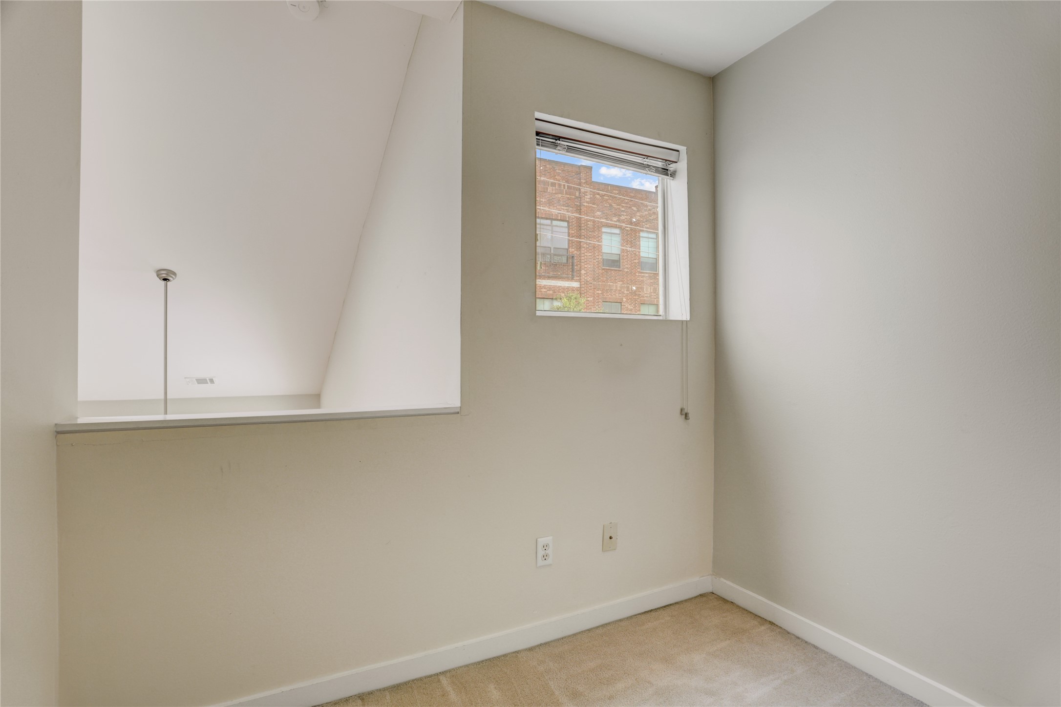 910 Ruthven Street Houston, TX 77019 - Photo 22 of 35 Hall or loft off the primary with window to the front and balcony overlooking living room. Above note the scuttle hole to access the attic.