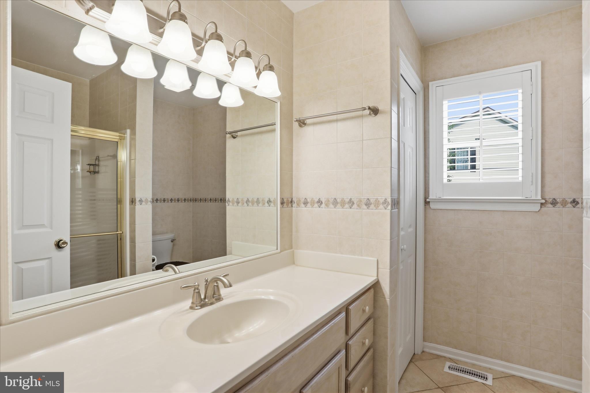 96 Phoenix Lane Falling Waters, WV 25419 - Photo 26 of 37 a bathroom with a sink vanity granite and a mirror