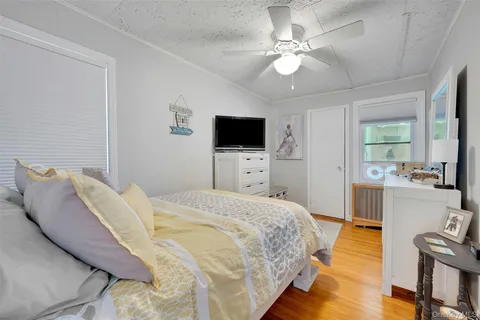 a bedroom with a bed and flat screen tv