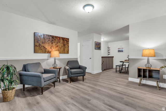 1539 East 450 South Springville, UT 84663 - Photo 6 of 49 Spacious interior featuring wood-finish flooring, two-tone wall treatment, and a white ceiling with a flush-mount light fixture