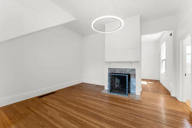 a view of room with window and wooden floor