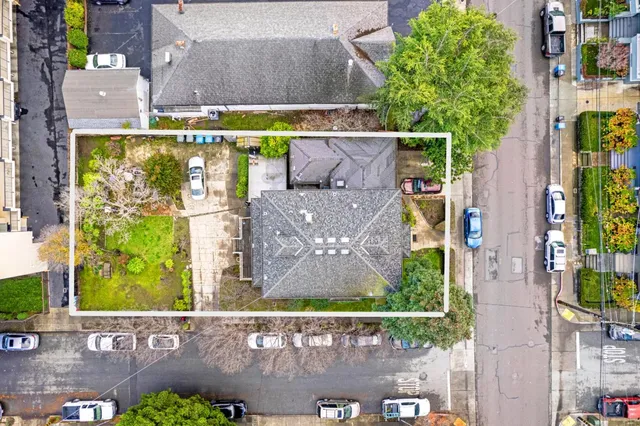 an aerial view of a house with a yard basket ball court and outdoor seating