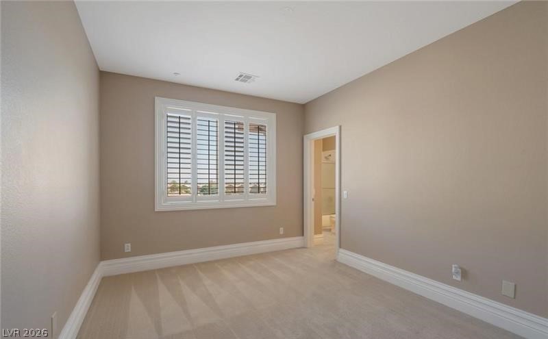 3 Tall Ruff Drive Las Vegas, NV 89148 - Photo 36 of 54 Well-lit room with ample space for personalization and an adjoining private bathroom.
