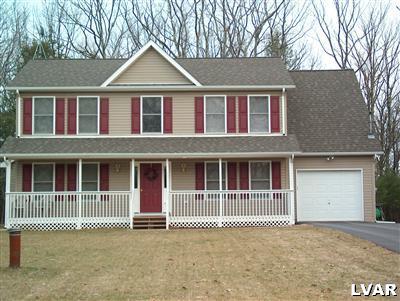 79 Turkey Ridge Kunkletown, PA 18058 - Photo 3 of 4 a front view of a house with a garden and fence