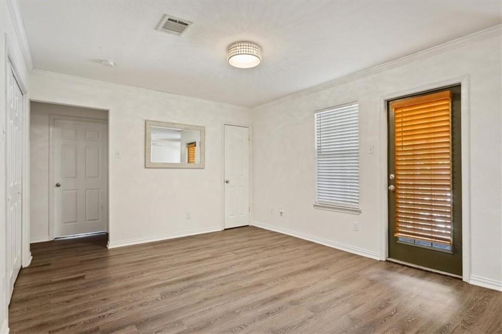 2306 Melissa Drive Waco, TX 76708 - Photo 7 of 22 an empty room with wooden floor and windows