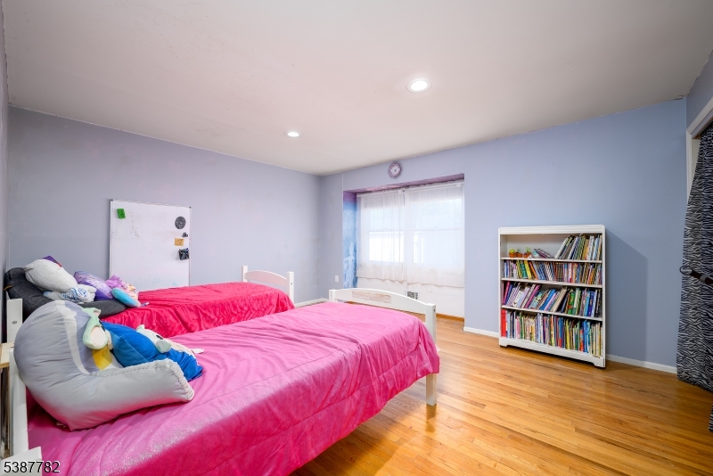 920 Robin Road Hillsborough, NJ 08844 - Photo 17 of 29 a bedroom with a bed and a book shelf