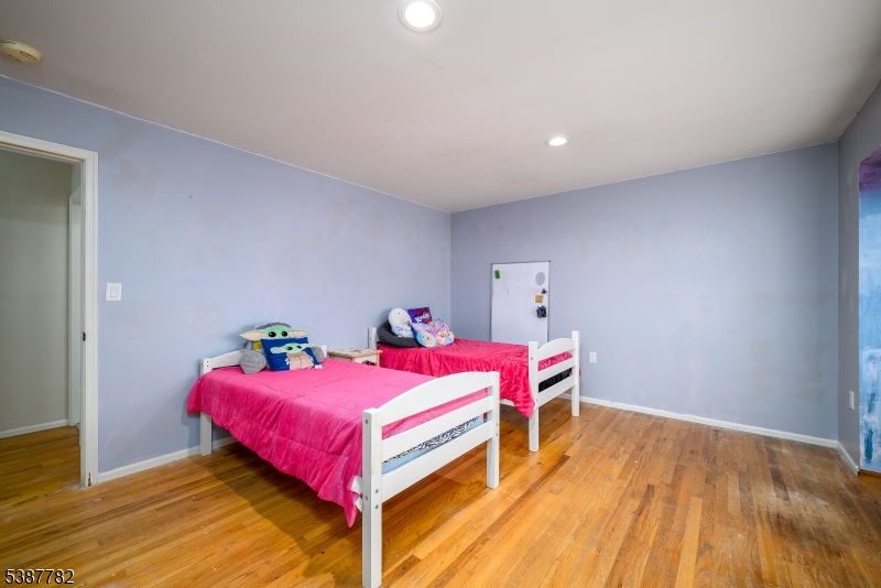 920 Robin Road Hillsborough, NJ 08844 - Photo 18 of 29 a bedroom with a bed and wooden floor