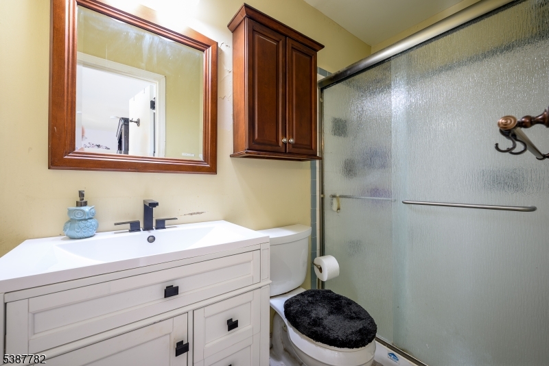 920 Robin Road Hillsborough, NJ 08844 - Photo 19 of 29 a bathroom with a sink a toilet and a mirror