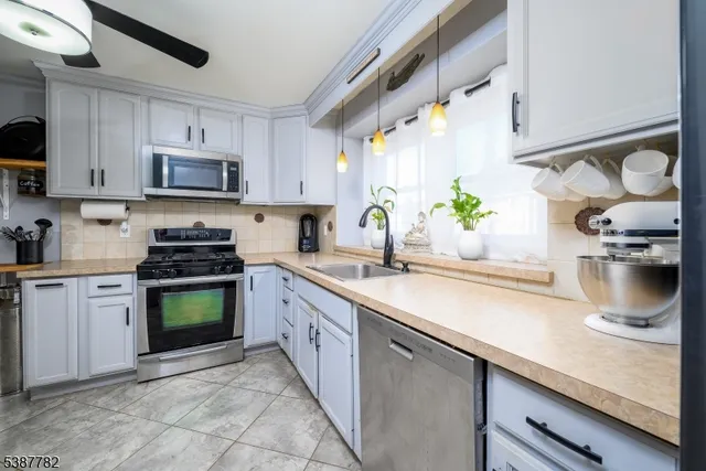 a kitchen with a sink cabinets and window