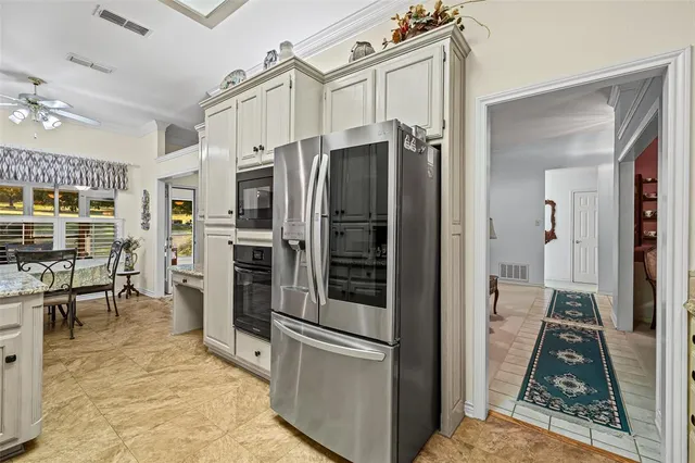 a kitchen with stainless steel appliances granite countertop a refrigerator sink and cabinets