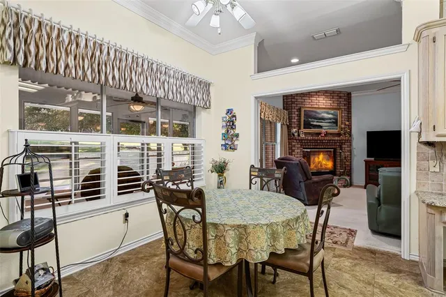 a spacious bedroom with a bed a ceiling fan and a dresser