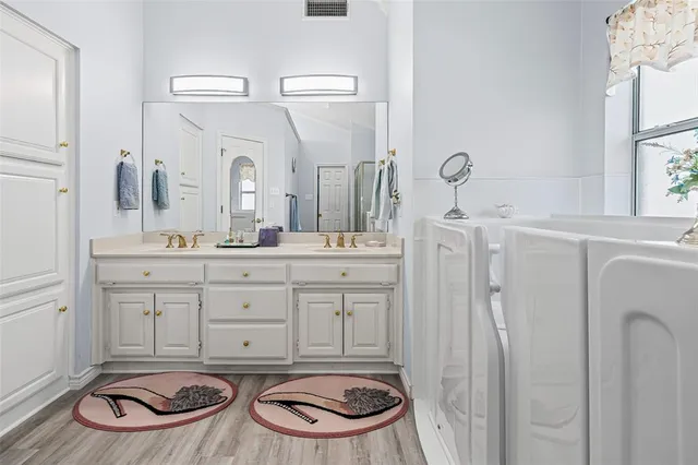 a view of an empty room with cabinet and entryway