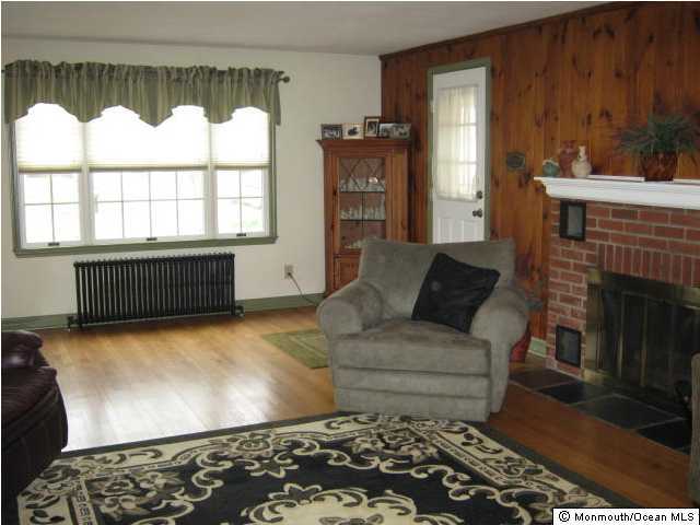2709 Woolley Road Wall, NJ 07719 - Photo 3 of 3 a living room with furniture and a fireplace
