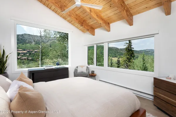 a bedroom with a large bed and a large window