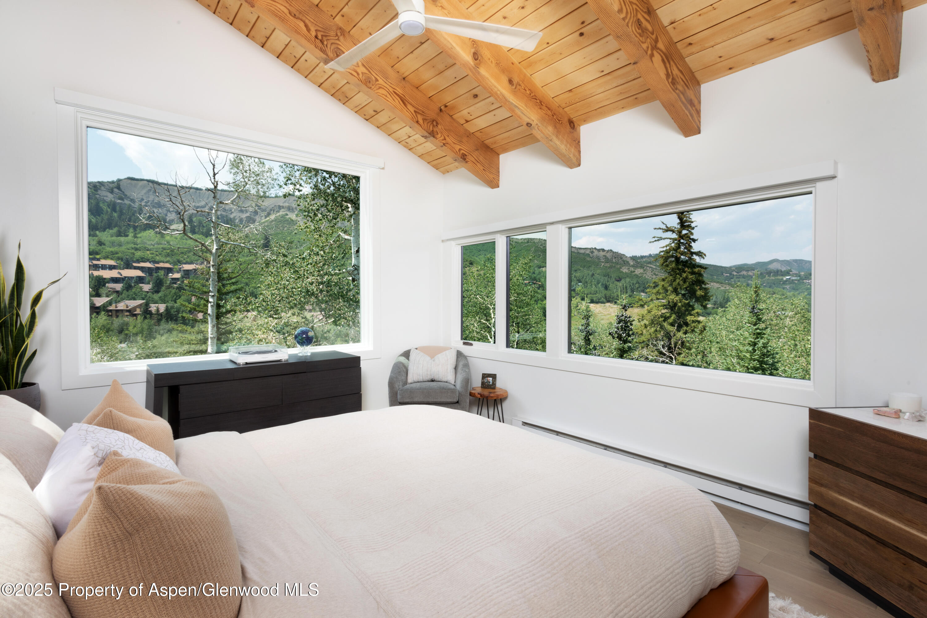 145 North Ridge Lane, Unit 2 Snowmass Village, CO 81615 - Photo 13 of 22 a bedroom with a large bed and a large window