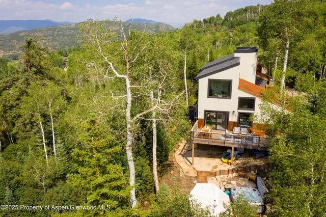 a aerial view of a house with a yard