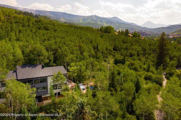 a view of a lush green hillside and a building