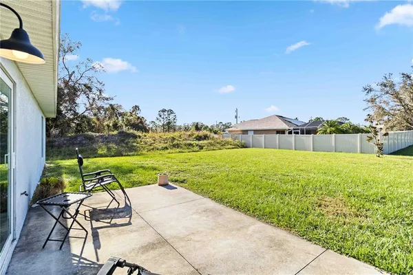 a view of backyard with swimming pool