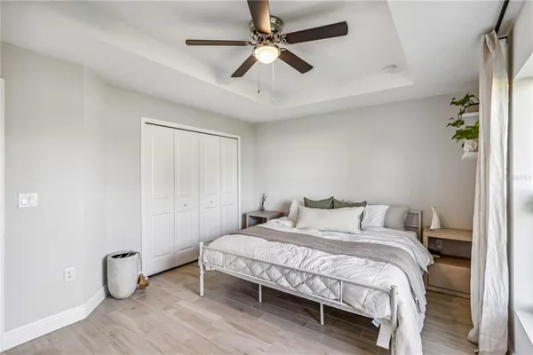 a bedroom with a bed and a ceiling fan