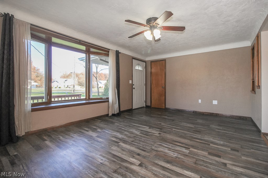 Living room with beautiful pella bow window and new vinyl flooring