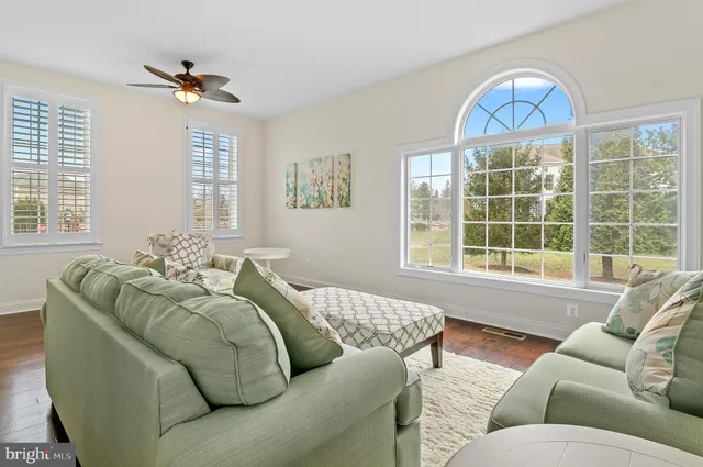 a living room with furniture wooden floor and a fireplace