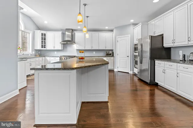 a bathroom with a granite countertop sink a toilet and a mirror