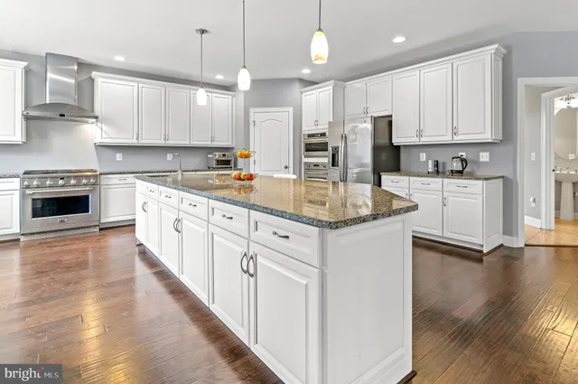 a white bath tub sitting next to a white toilet and a sink