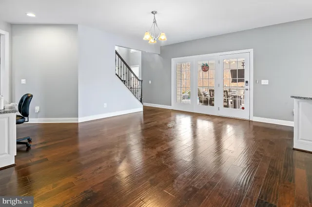 a bedroom with a bed a couch and a potted plant