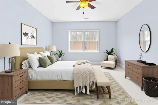 a bedroom with a bed a couch and a chandelier