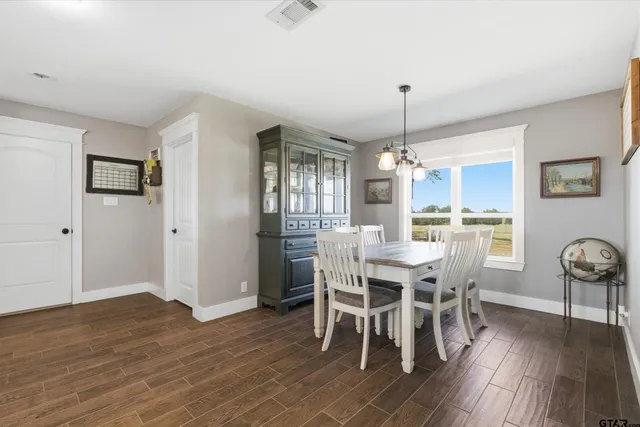 a dining room with furniture window and wooden floor