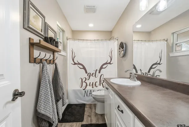 a bathroom with double vanity and a shower