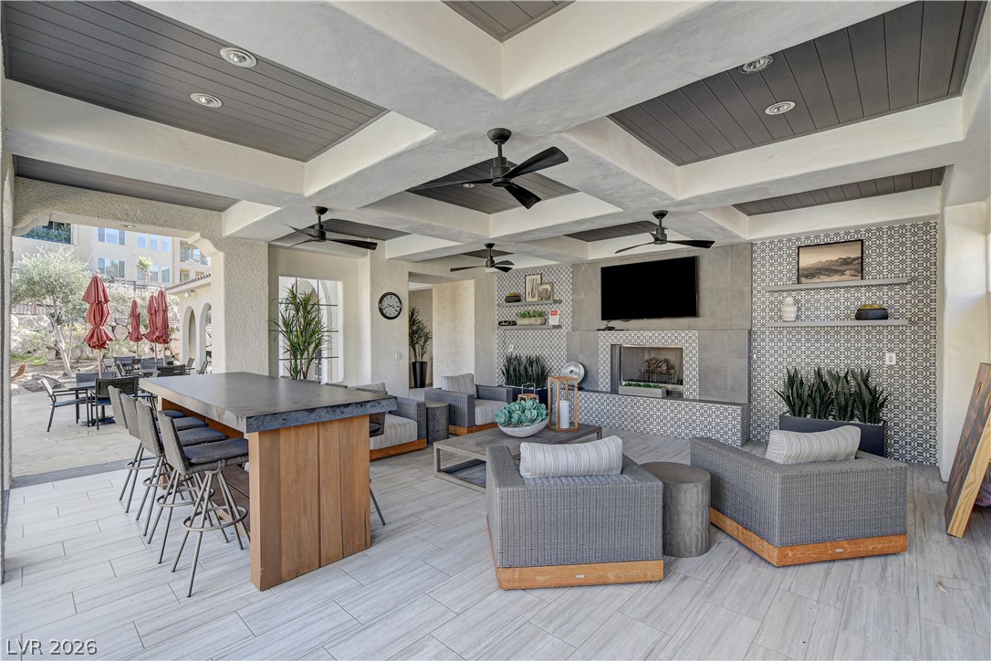 2555 Hampton Road, Unit 2207 Henderson, NV 89052 - Photo 56 of 74 An inviting outdoor lounge area features an entertainment wall and bar for relaxed gatherings.