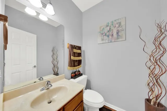 a bathroom with a sink mirror and toilet