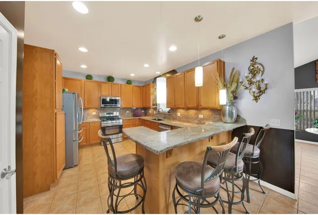 a kitchen with a table and chairs in it