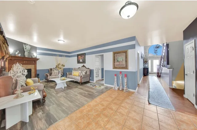 a living room with furniture fireplace and a window