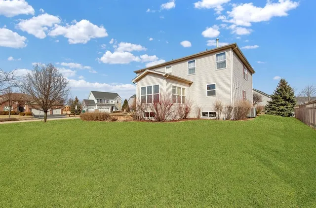a view of an house with backyard space and garden