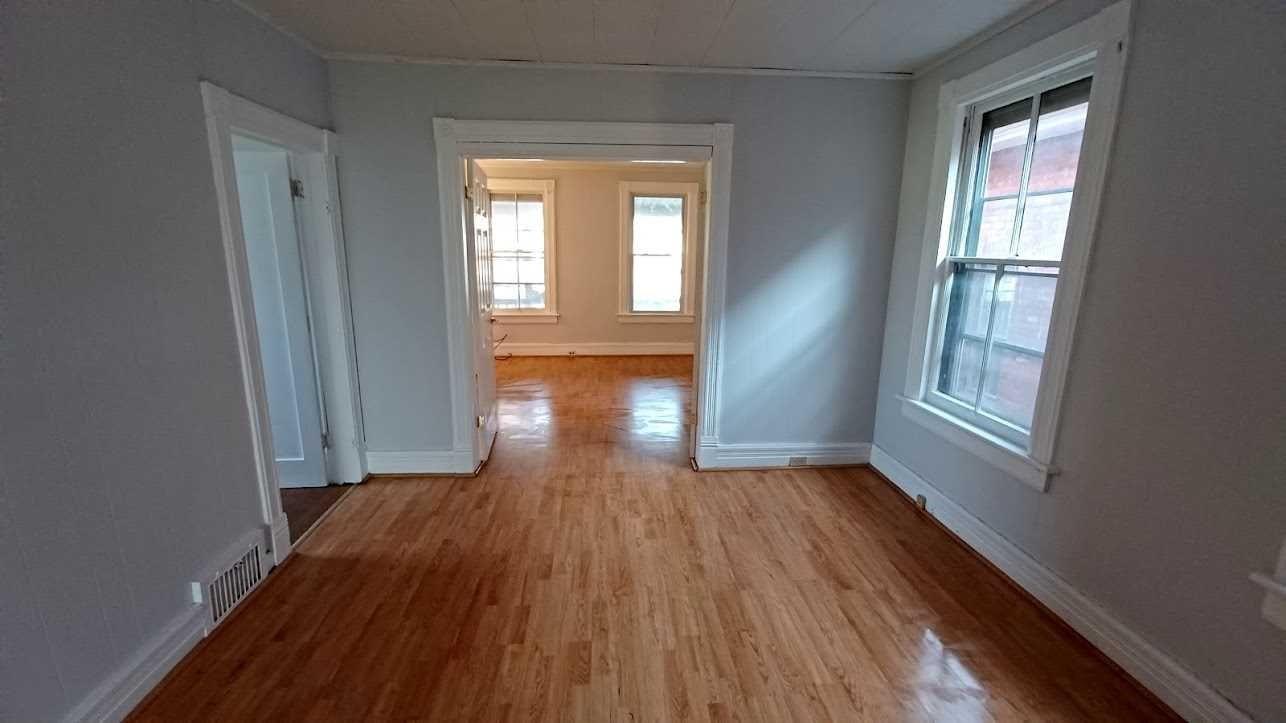 200 North Hamilton Street, Unit 2 Poughkeepsie, NY 12601 - Photo 1 of 1 an empty room with wooden floor and windows