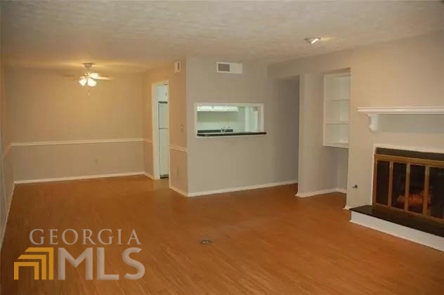a view of an empty room with a fireplace