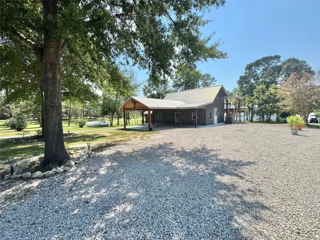 a view of a house with yard and a tree