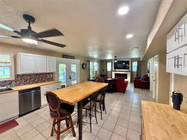 a large kitchen with a table and chairs