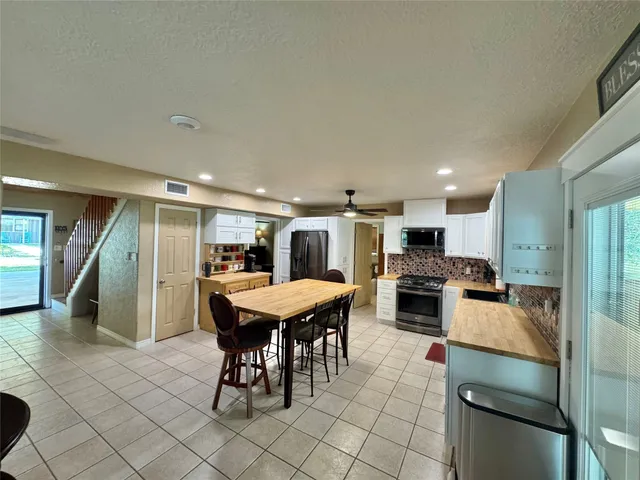 a kitchen with stainless steel appliances kitchen island granite countertop a sink and cabinets