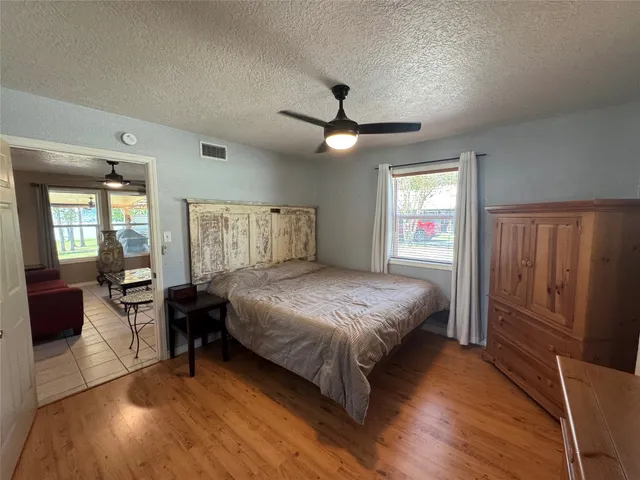 a bedroom with a bed and wooden floor